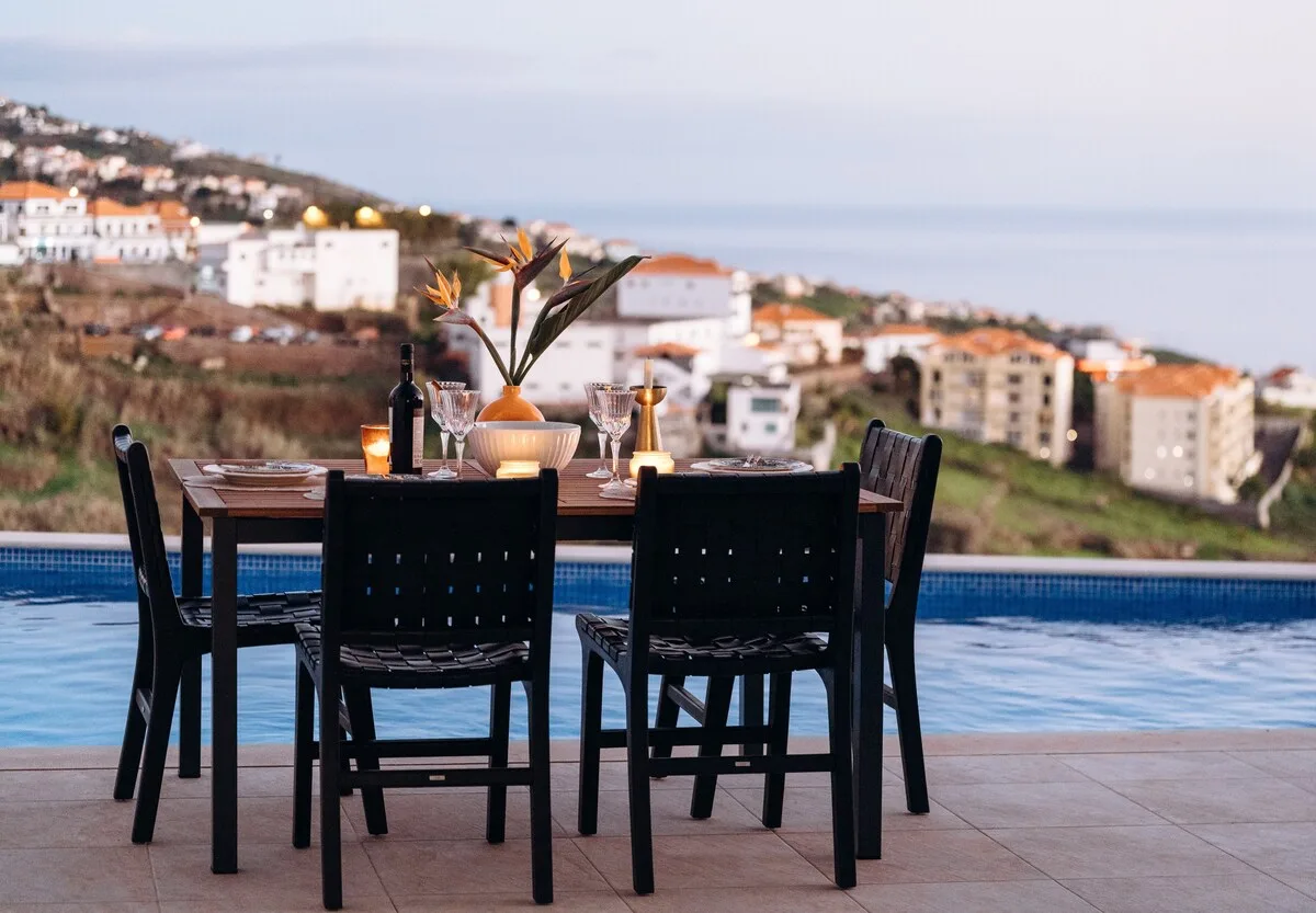 Dinner set at the edge of the heated pool