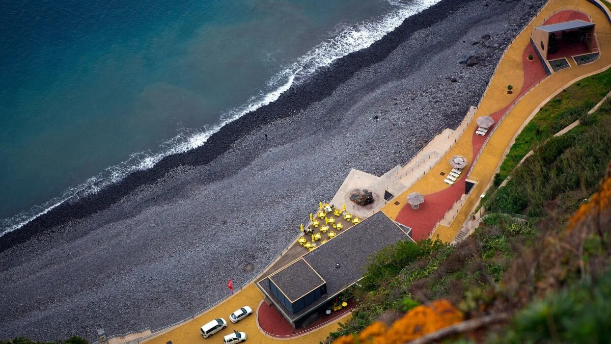 Caniço's stony beach and seafront promenade seen from above