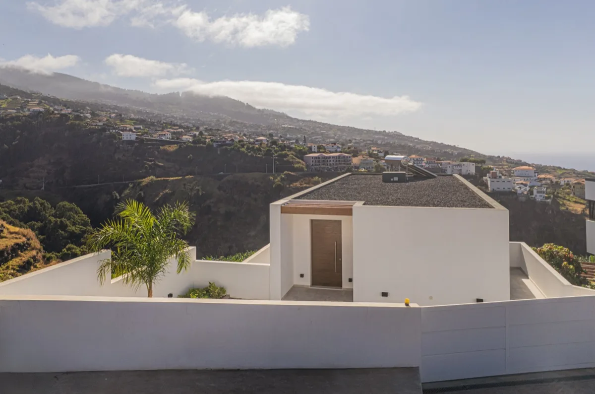 The entrance to Villa Calma against the hills of Madeira